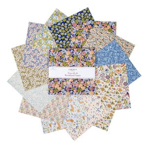 May include: A set of 12 fabric squares featuring a variety of floral patterns in pastel colors. The fabric squares are labeled "Liberty of London Tree of Life Woodland Pastels."