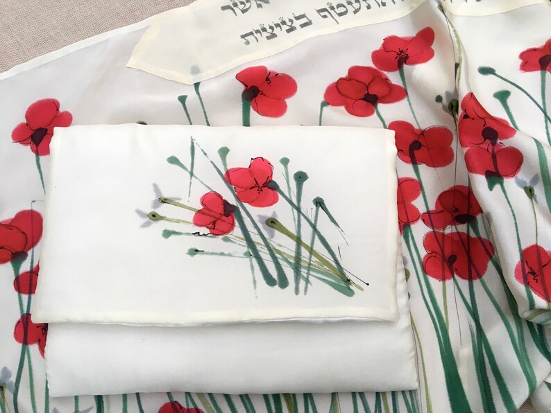 White silk Tallit, with red anemones. Includes a Tallit Bag. Can be ordered with name in Hebrew or English on the back of the bag
