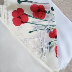 White silk Tallit, with red anemones. Includes a Tallit Bag. Can be ordered with name in Hebrew or English on the back of the bag