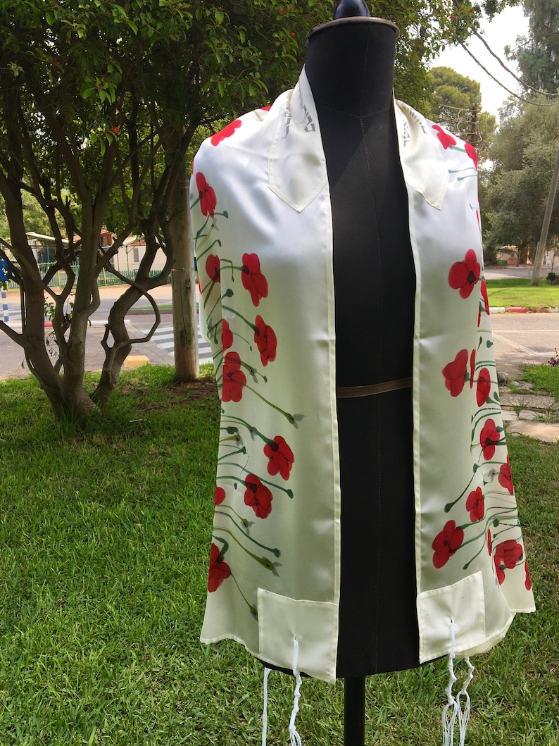 White silk Tallit, with red anemones. Includes a Tallit Bag. Can be ordered with name in Hebrew or English on the back of the bag