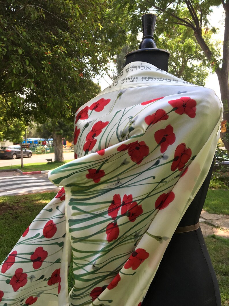 White silk Tallit, with red anemones. Includes a Tallit Bag. Can be ordered with name in Hebrew or English on the back of the bag
