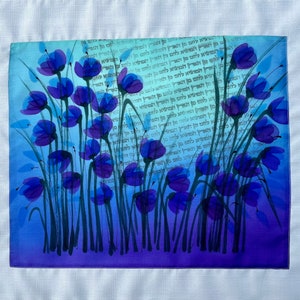 Purple Anemones Bread Cover, on teal blue and purple colors. The flowers are above text of Shabbat Shalom, or Hamotze lechem min Haaretz.