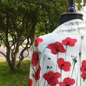 White silk Tallit, with red anemones. Includes a Tallit Bag. Can be ordered with name in Hebrew or English on the back of the bag