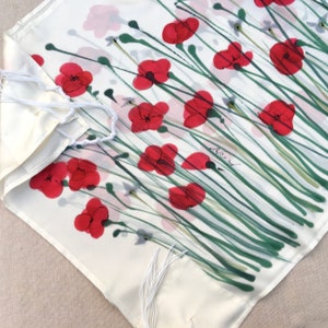 White silk Tallit, with red anemones. Includes a Tallit Bag. Can be ordered with name in Hebrew or English on the back of the bag