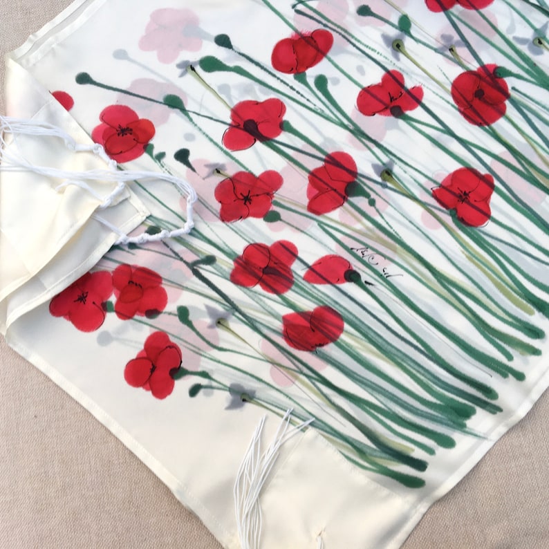 White silk Tallit, with red anemones. Includes a Tallit Bag. Can be ordered with name in Hebrew or English on the back of the bag