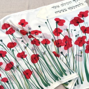 White silk Tallit, with red anemones. Includes a Tallit Bag. Can be ordered with name in Hebrew or English on the back of the bag