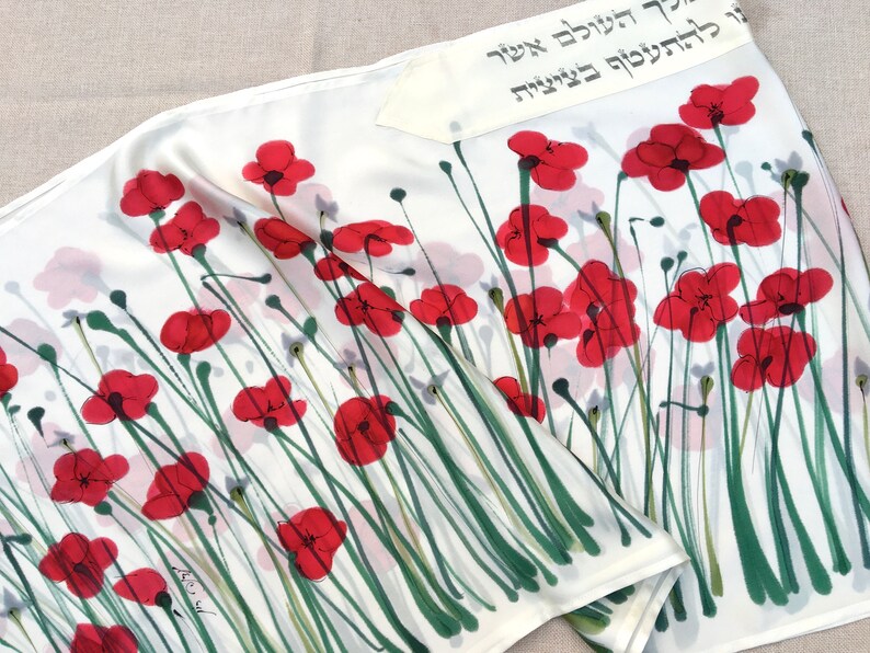 White silk Tallit, with red anemones. Includes a Tallit Bag. Can be ordered with name in Hebrew or English on the back of the bag