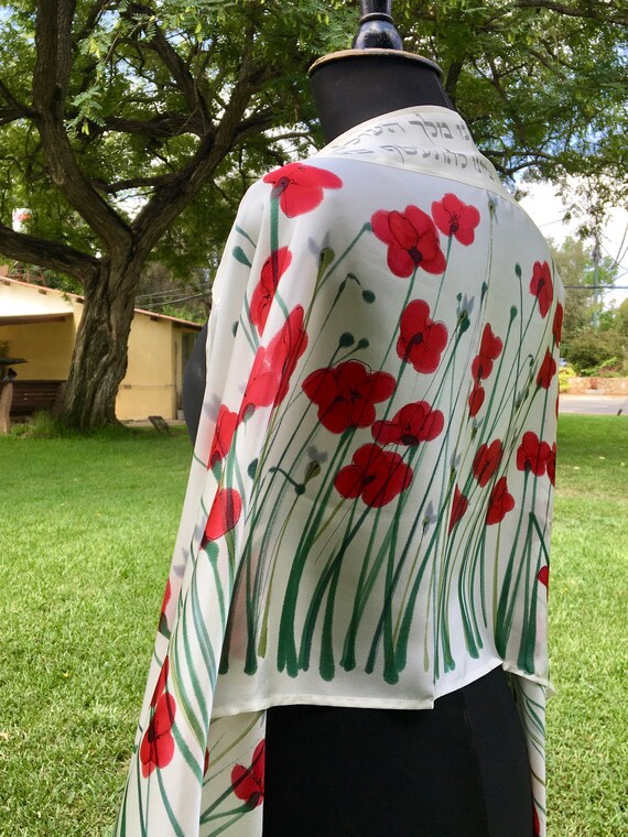 White silk Tallit, with red anemones. Includes a Tallit Bag. Can be ordered with name in Hebrew or English on the back of the bag