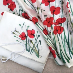 White silk Tallit, with red anemones. Includes a Tallit Bag. Can be ordered with name in Hebrew or English on the back of the bag