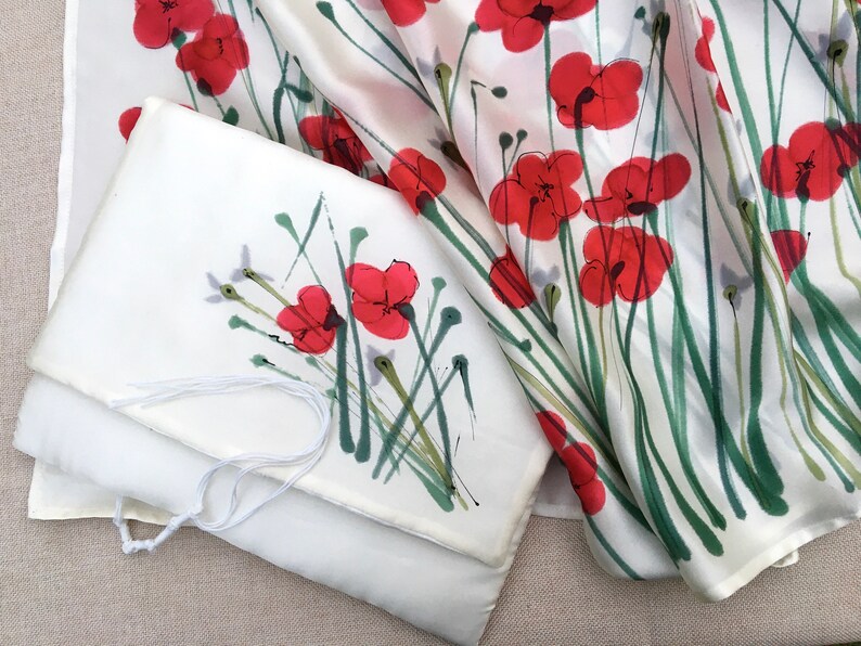 White silk Tallit, with red anemones. Includes a Tallit Bag. Can be ordered with name in Hebrew or English on the back of the bag