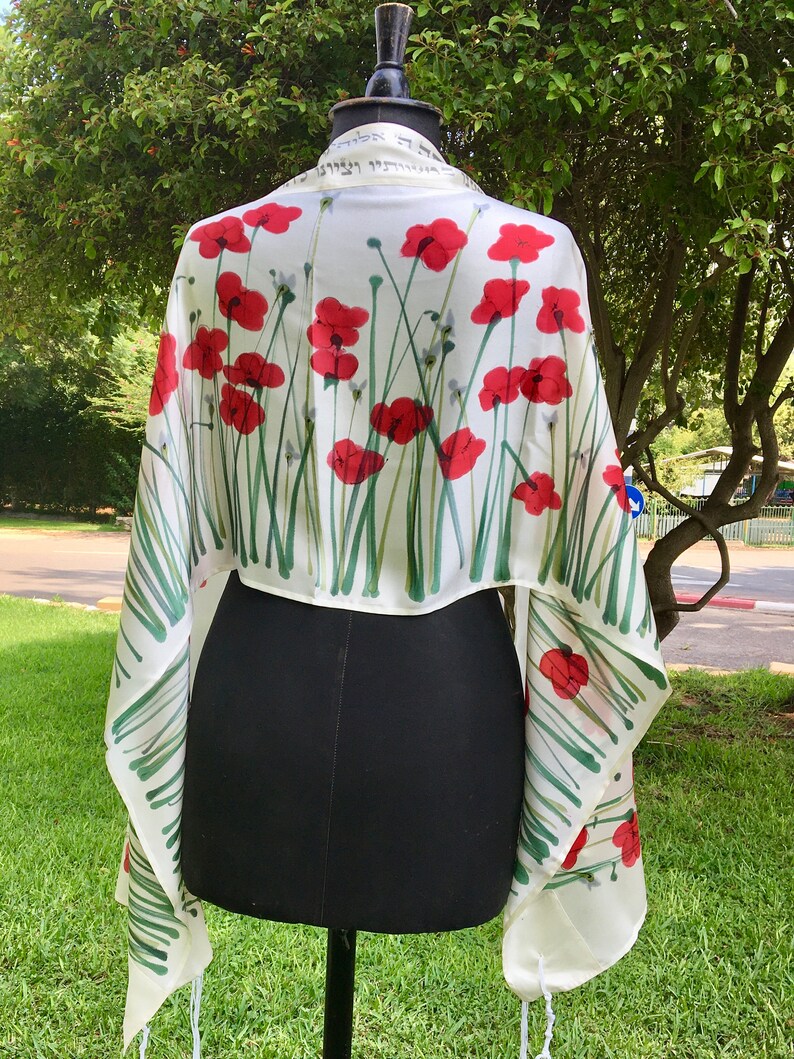 White silk Tallit, with red anemones. Includes a Tallit Bag. Can be ordered with name in Hebrew or English on the back of the bag