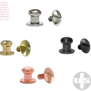 May include: Assortment of six metal rivets, including nickel, brass, black, and copper finishes. Each rivet has a domed head and a flat base. The rivets are arranged in three pairs, with the screw portion of each rivet visible.