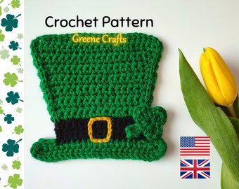 May include: Crochet pattern for a green leprechaun hat with a black band and a gold buckle. The hat has a green shamrock on the side. The pattern is available in both US and UK English.