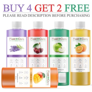 May include: Six glass bottles of essential oil with labels featuring different scents: Lavender, Cherry, Apple Fantasy, Sweet Orange, and Tropical Mango. The bottles are arranged in a row with the text "BUY 4 GET 2 FREE" and "PLEASE READ DESCRIPTION BEFORE PURCHASING" above them.