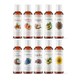 May include: Ten small amber glass bottles with white lids, each containing a different type of oil. The bottles are labeled with the name of the oil, such as Almond Oil, Apricot Kernel Oil, Argan Oil, Avocado Oil, Castor Oil, Fractionated Coconut Oil, Grapeseed Oil, Jojoba Oil, Olive Oil Pomace, and Sunflower Oil. Each bottle has a small image of the source of the oil, such as almonds, apricots, argan nuts, avocados, castor beans, coconuts, grapes, jojoba beans, olives, and sunflowers.