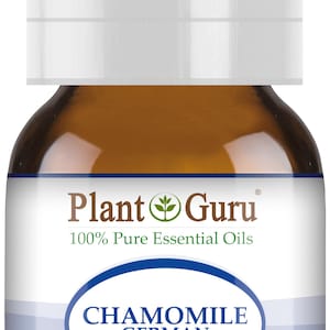 May include: A brown glass bottle of Plant Guru Chamomile German essential oil. The label includes the text "100% Pure Essential Oils" and "1/6 fl oz. (5ml)." The bottle has a white cap.