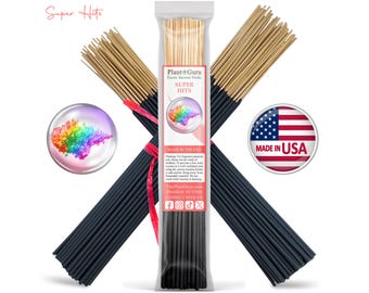 May include: A collection of black incense sticks with natural wooden tips, arranged in a cross pattern. A central clear plastic package features the Plant Guru logo, the text Super Hits, and a colorful smoke graphic. A circular American flag icon is included.