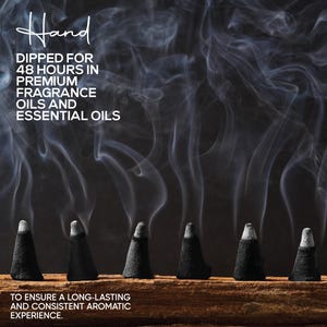 May include: Six black incense cones on a wooden surface, with white smoke against a dark backdrop. Text states "Hand dipped for 48 hours in premium fragrance oils and essential oils" to ensure a long-lasting aromatic experience.