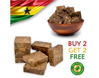 May include: Image of raw, brown African black soap in various forms. Some are stacked, others are in a wooden bowl. The Ghana flag is in the background, along with text that reads "BUY 2 GET 2 FREE" and a "100% Natural Product" seal.