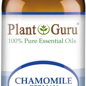May include: A brown glass bottle of Plant Guru Chamomile German essential oil. The label includes the text "100% Pure Essential Oils" and "1 fl oz. (30 ml)." The bottle has a white cap.
