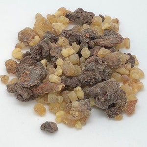 May include: A close-up of a pile of brown and yellow resin pieces. The resin is used in incense and other spiritual practices.