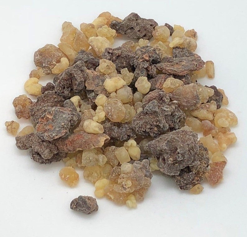 May include: A close-up of a pile of brown and yellow resin pieces. The resin is used in incense and other spiritual practices.