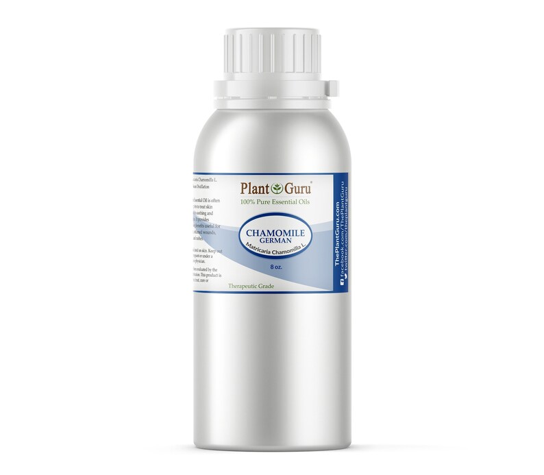 May include: A silver metal bottle of Chamomile German essential oil from Plant Guru. The label includes the text "100% Pure Essential Oils" and "Therapeutic Grade". The bottle contains 8 oz of oil.