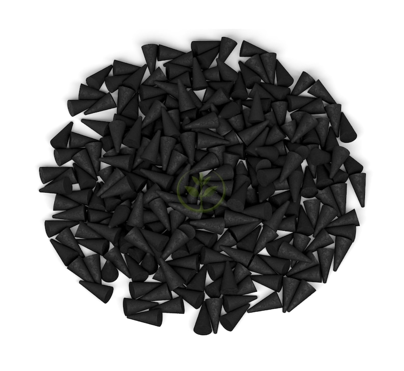 May include: A large pile of black incense cones. The cones are arranged in a circular pattern on a white background.