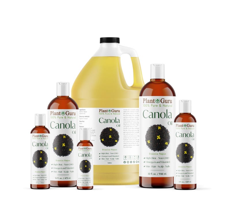 May include: A collection of canola oil bottles and a large jug. The bottles are amber-colored with white labels and black text. The labels read "Plant Guru Canola Oil" and feature a black graphic with yellow accents. The jug is yellow.