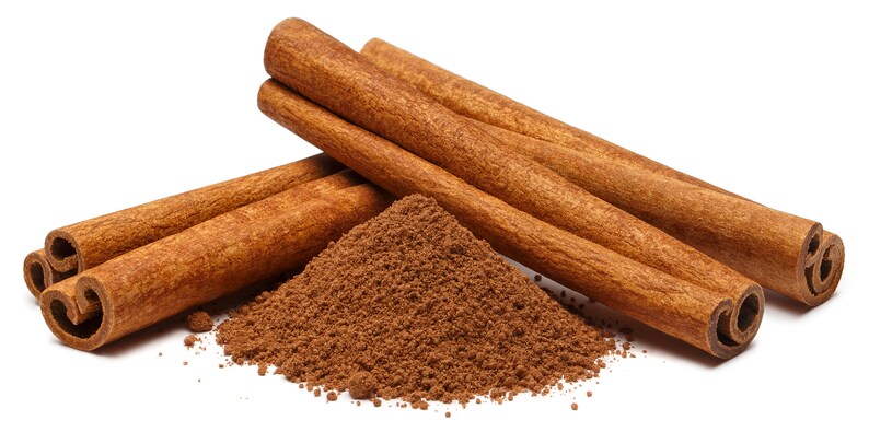 May include: Close-up of cinnamon sticks and ground cinnamon. The cinnamon sticks are a warm brown color, with a textured surface and curled ends. A pile of ground cinnamon is next to the sticks. The image is on a white background.