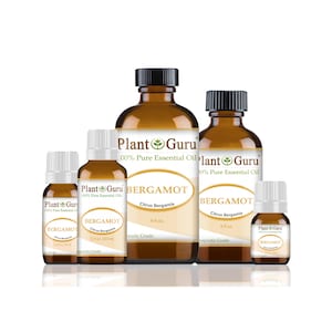 May include: An assortment of amber-colored glass bottles of bergamot essential oil, labeled "Plant Guru." The bottles vary in size, with black or white caps, and feature white labels with the product name and details. The largest bottle is labeled 4 fl oz.