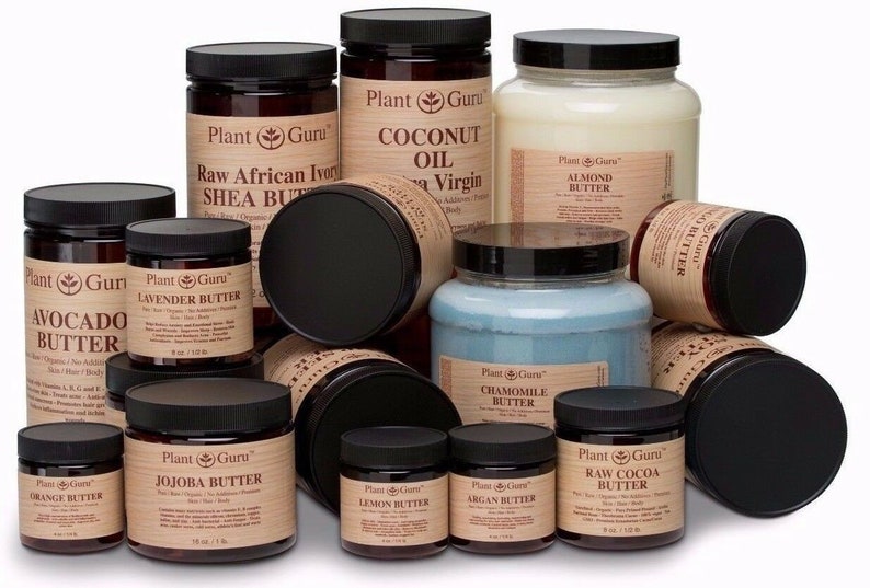 May include: A collection of 11 brown glass jars with black lids containing various butters and oils. The jars are labeled with the brand name "Plant Guru" and the type of butter or oil, such as "Avocado Butter", "Raw African Ivory Shea Butter", and "Coconut Oil".