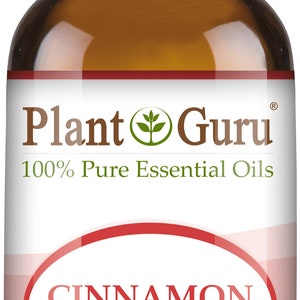 May include: A brown glass bottle of Plant Guru Cinnamon Leaf essential oil. The label reads "CINNAMON LEAF Cinnamomum Verum" and "1/3 fl oz. (10 ml)." The bottle has a white cap.
