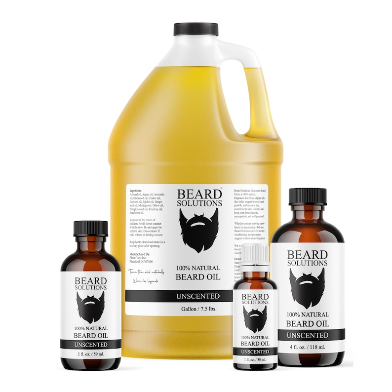 May include: A collection of beard oil bottles and a large jug. The bottles are brown with black caps and white labels that read "BEARD SOLUTIONS" and "100% NATURAL BEARD OIL UNSCENTED." The large jug is yellow and has a black cap and a white label.