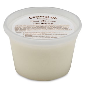 May include: A white plastic container of Plant Guru Extra Virgin Coconut Oil. The label reads "Coconut Oil", "Extra Virgin", "Plant Guru", "100% Natural", and includes a list of uses and benefits. The container is filled with a white, opaque liquid.