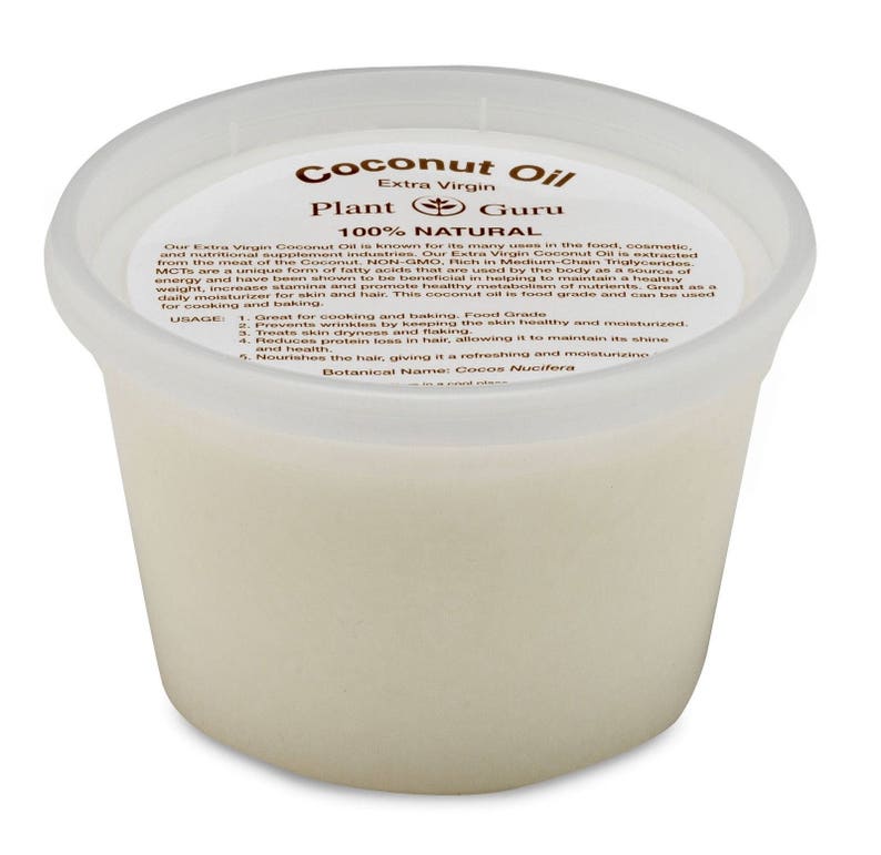 May include: A white plastic container of Plant Guru Extra Virgin Coconut Oil. The label reads "Coconut Oil", "Extra Virgin", "Plant Guru", "100% Natural", and includes a list of uses and benefits. The container is filled with a white, opaque liquid.