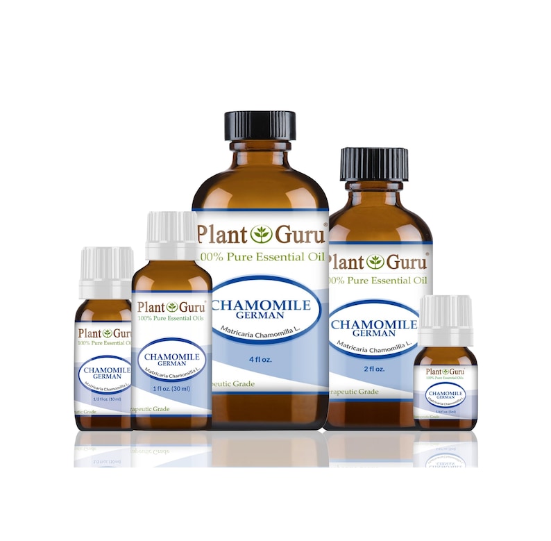 May include: Several amber glass bottles of Plant Guru Chamomile German essential oil. The bottles vary in size, with black caps and white labels featuring blue text. The labels include the words "Chamomile German" and "100% Pure Essential Oil."