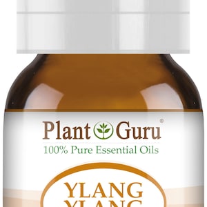 May include: A brown glass bottle of Ylang Ylang essential oil with a white cap. The label reads "Plant Guru 100% Pure Essential Oils" and "YLANG YLANG Cananga Odorata". The bottle contains 5ml of oil.