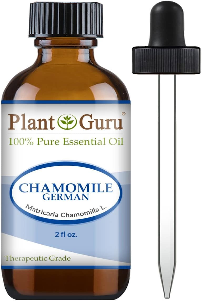 May include: A brown glass bottle of Plant Guru Chamomile German 100% Pure Essential Oil with a black cap and a dropper. The label reads "2 fl oz." and "Therapeutic Grade."
