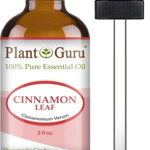 May include: A brown glass bottle of Plant Guru Cinnamon Leaf essential oil with a black dropper. The label reads "100% Pure Essential Oil" and "Cinnamon Leaf, Cinnamomum Verum, 2 fl oz." The product is labeled as "Therapeutic Grade."