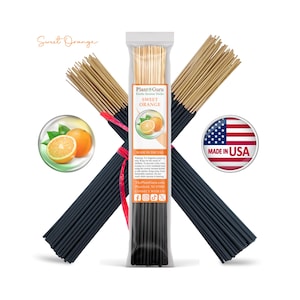 May include: A bundle of black incense sticks with tan tips, packaged in a clear plastic sleeve labeled Plant Guru Sweet Orange. The packaging features an orange graphic, text, and a Made in USA badge. Two additional bundles are crossed behind it.