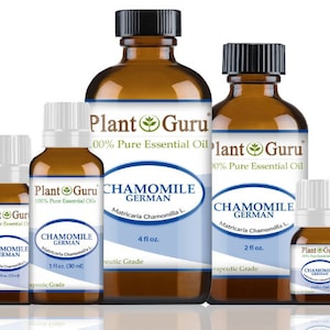 May include: Four amber glass bottles of German Chamomile essential oil in various sizes, labeled "Plant Guru 100% Pure Essential Oil" and "Chamomile German Matricaria Chamomilla L."  The bottles are labeled with sizes of 1 fl oz, 2 fl oz, and 4 fl oz.