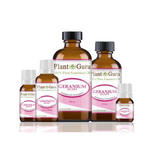 May include: A collection of brown glass bottles of essential oil, labeled "Plant Guru" and "Geranium Egypt." The bottles vary in size, with black caps and white labels featuring pink accents. The essential oils are therapeutic grade.