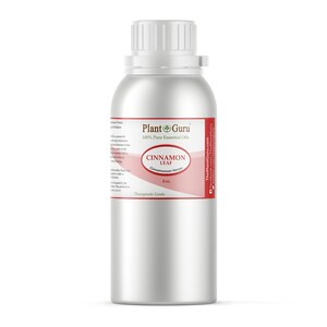 May include: A silver metal bottle of cinnamon leaf essential oil. The label reads "Plant Guru 100% Pure Essential Oils" and "Cinnamon Leaf Cinnamomum Verum 8 oz." The bottle has a white cap and a red and white label.