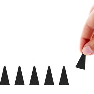 May include: A hand holding a black incense cone, with several other cones arranged in a row. The cones are dark and conical, set against a white background. The image highlights the shape and color of the incense.