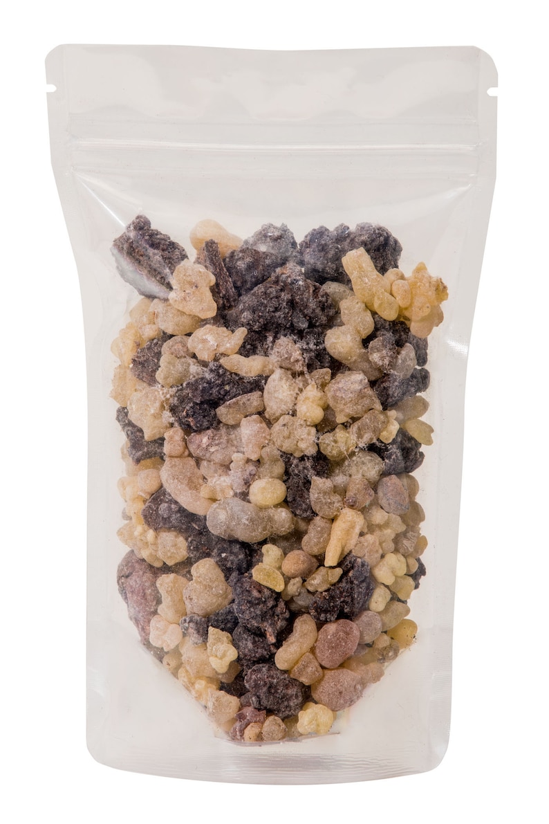 May include: A clear plastic resealable bag filled with a mixture of brown, tan, and light brown resin pieces.