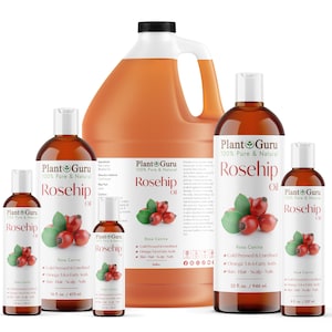 May include: Five bottles of Plant Guru 100% Pure & Natural Rosehip Oil in various sizes. The bottles are amber glass with white caps and labels. The labels feature a green leaf logo, the product name, and a red rosehip illustration. The bottles are arranged in a row from largest to smallest.