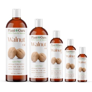 May include: Four bottles of Plant Guru 100% Pure & Natural Walnut Oil in different sizes. The bottles are amber glass with white caps and labels. The labels feature a green leaf logo and the text "Plant Guru" in green and white. The bottles are arranged in a row from largest to smallest. The largest bottle is 32 fl. oz./946 ml., the next is 16 fl. oz./473 ml., the next is 8 fl. oz./237 ml., and the smallest is 2 fl. oz./59 ml.