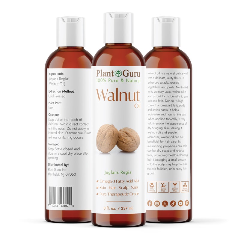 May include: Two amber glass bottles of Plant Guru 100% Pure & Natural Walnut Oil, with white caps and labels. The label features a walnut, the words "Walnut Oil", and the text "Juglans Regia". The bottle on the right has a list of benefits of walnut oil for skin, hair, and nails. The bottle is 8 fl. oz. / 237 ml.