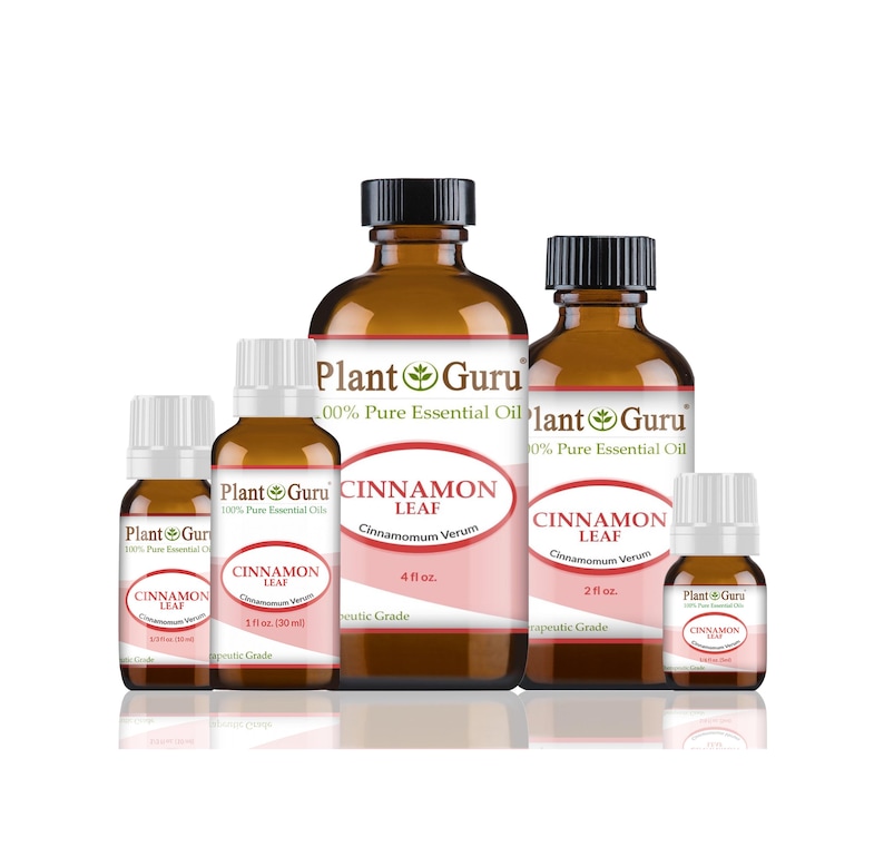May include: A collection of amber glass bottles of Plant Guru Cinnamon Leaf essential oil. The bottles vary in size, with black caps and white labels featuring the product name and botanical information. The labels have a pink oval design.